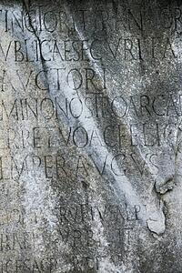 Close-up of script engraved into stone at the Roman Forum in Rome, Italy