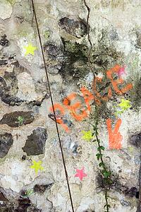 Close-up of the word peace and stars spray painted on concrete
