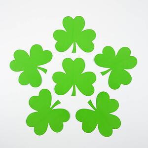 Group of green paper shamrocks arranged together