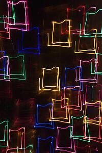 Multicolored lights forming abstract square pattern from motion blur.