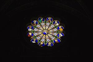 Religious themed stained glass window in Rome, Italy.