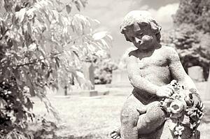 Infrared graveyard scenic with cherub statue