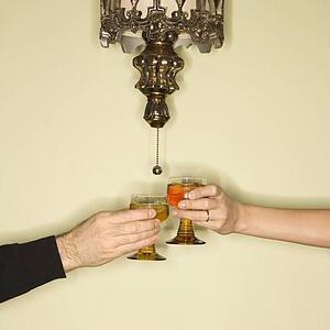 Mid-adult couples hands toasting glasses