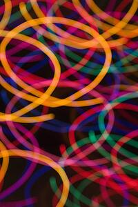 Multicolored lights forming abstract circular pattern from motion blur.