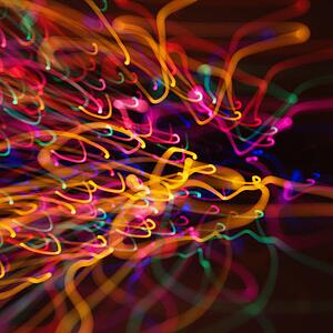 Multicolored lights forming abstract squiggle pattern from motion blur.