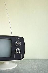 Still life of vintage television set with antenna raised.