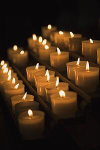 Group of lit candles in Rome, Italy