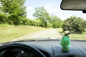Hula girl on dashboard of car interior
