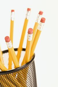 Group of pencils in a pencil holder with eraser ends up