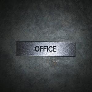 Metal office sign on textured background