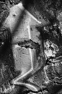 Close-up black and white of graffiti on textured concrete