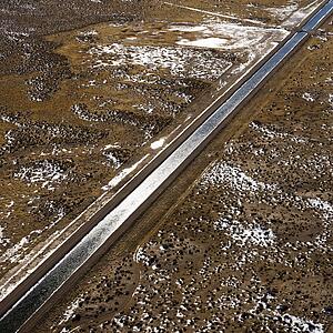 Aerial landscape of water canal running though rural Colorado