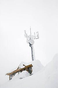 Cabin and antenna covered in snow