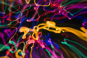 Multicolored lights forming abstract squiggle pattern from motion blur