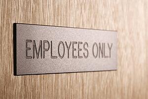 Employees only sign on wooden door