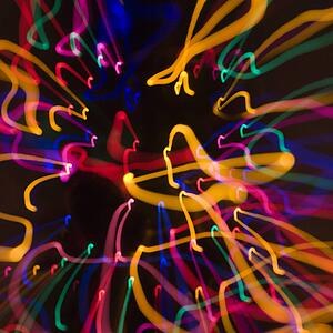 Multicolored lights forming abstract squiggle pattern from motion blur
