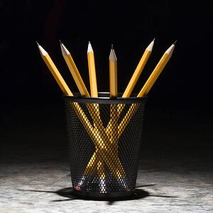 Group of pencils in a wire mesh pencil holder