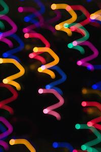 Multicolored lights forming abstract squiggle pattern from motion blur