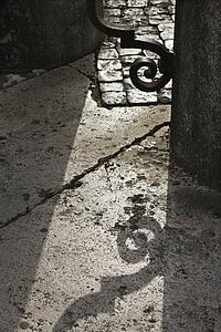 Shadow casted on ground from iron gate in Saint Peter's Square, Vatican City, Italy.