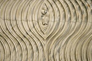 Close-up of engraved couple surrounded by line pattern in Rome, Italy