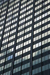 Side of glass building in urban setting