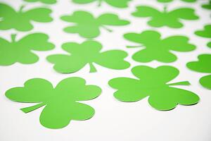 Group of green paper shamrocks on white