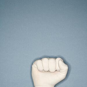 Fist wearing white rubber glove