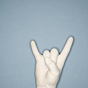 Hand wearing white rubber glove making gesture