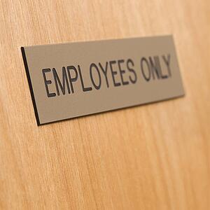 Employees only sign on wooden door