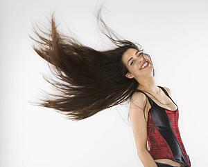 Woman wearing corset swinging her hair