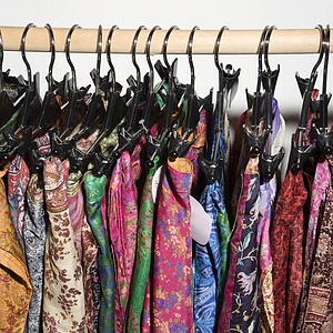 Colorful clothes hanging on rack.