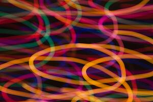 Multicolored lights forming abstract circular pattern from motion blur