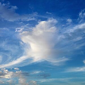 Wispy cloud formations against clear blue sky