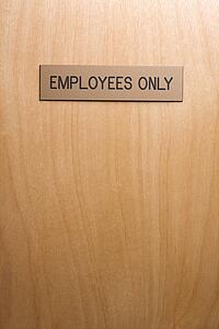 Employees only sign on wooden door