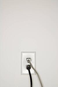 Two cords plugged into electrical wall outlet
