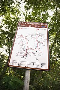 Sign with map showing routes in Tuscany, Italy