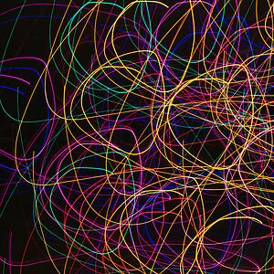 Multicolored lights forming abstract circular pattern from motion blur