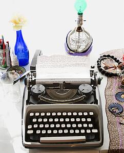 Typewriter with typed on paper sitting on counter