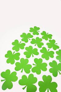 Group of green paper shamrocks on white