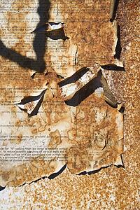 Old car manual torn and covered with dirt
