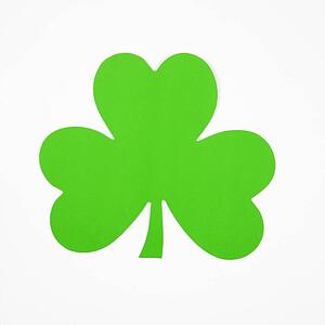 Single green paper shamrock on white