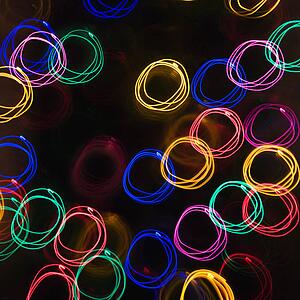 Multicolored lights forming abstract circle pattern from motion blur