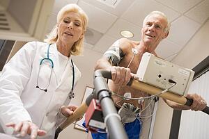 Doctor With Patient While They Run Being Monitored