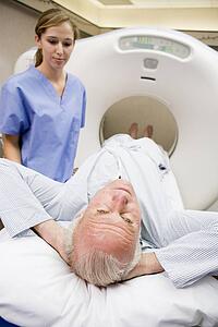 Nurse With Patient As They Prepare For A Computerized Axial Tomography (CAT) Scan
