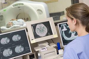 Nurse Monitoring Patient Having A Computerized Axial Tomography (CAT) Scan