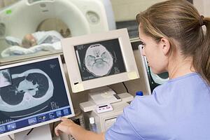Nurse Monitoring Patient Having A Computerized Axial Tomography (CAT) Scan