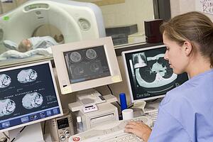 Nurse Monitoring Patient Having A Computerized Axial Tomography (CAT) Scan