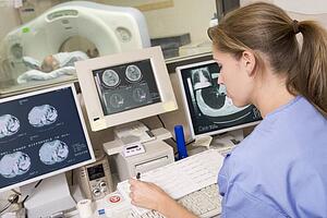 Nurse Monitoring Patient Having A Computerized Axial Tomography (CAT) Scan