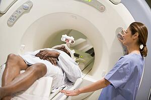 Nurse With Patient As They Prepare For A Computerized Axial Tomography (CAT) Scan