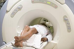 Nurse With Patient As They Prepare For A Computerized Axial Tomography (CAT) Scan